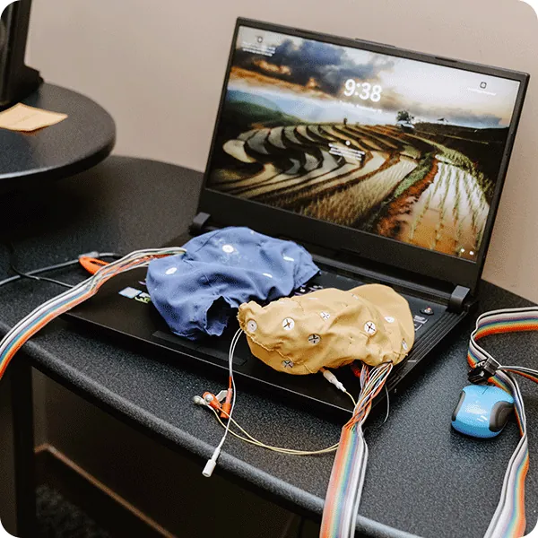BrainMaster neurofeedback caps beside a laptop