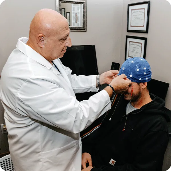 Dr. Tony fitting a neurofeedback cap to a patient