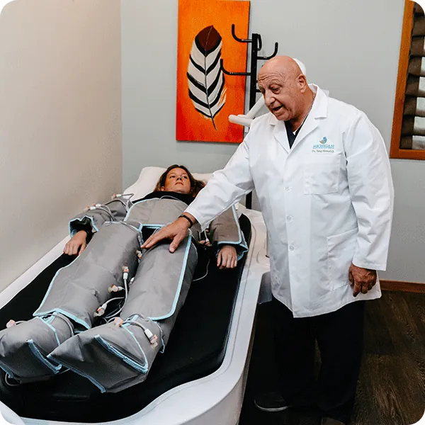 Dr. Tony checking on a patient during pressotherapy
