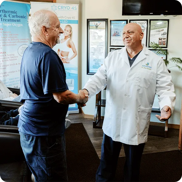 Dr. Tony greeting a patient in the waiting room