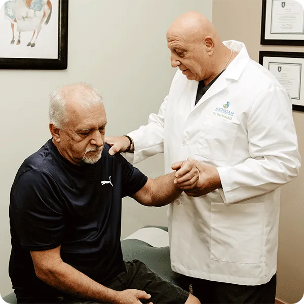 Dr. Tony checks a patient’s range of motion