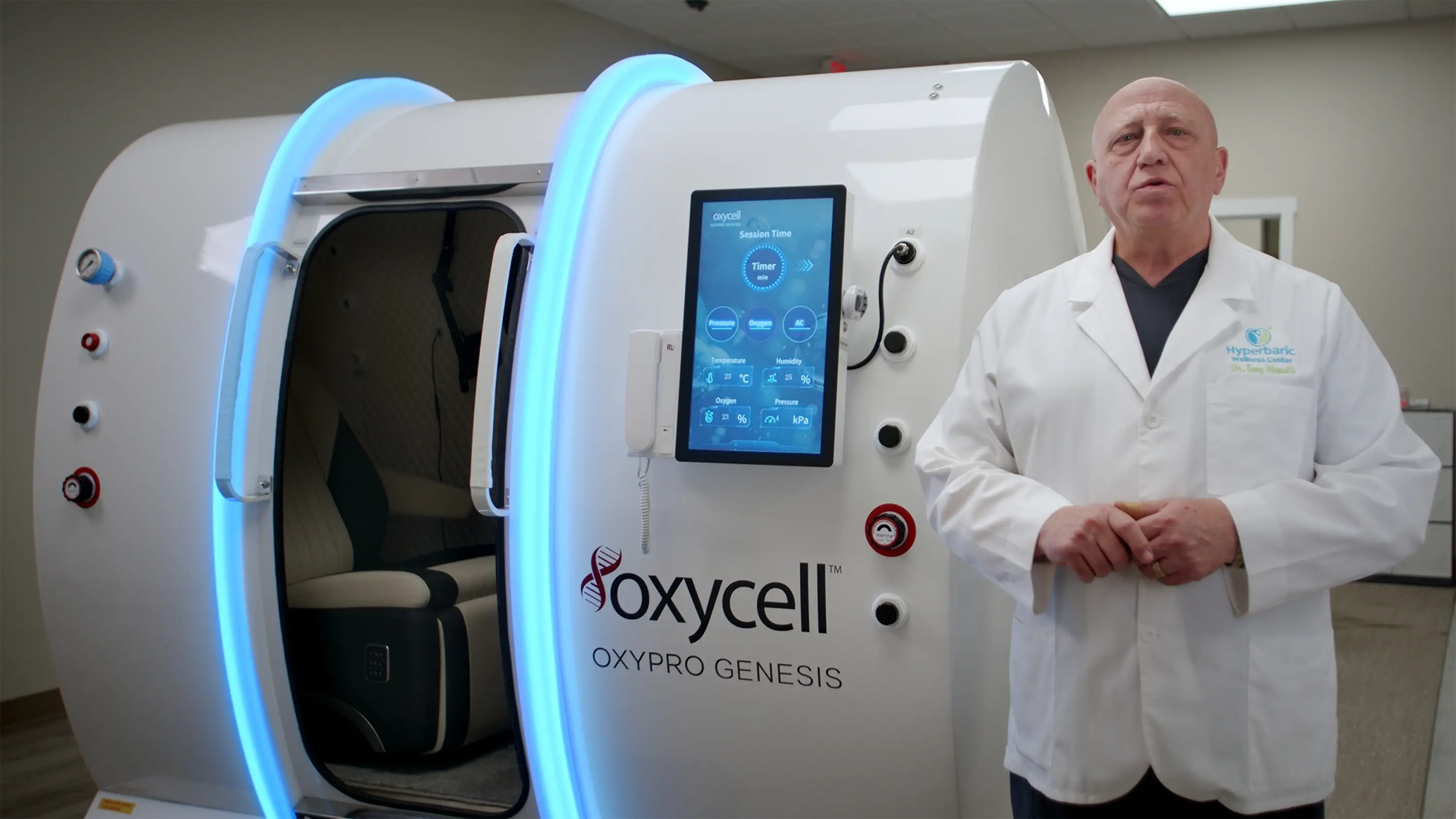 Dr. Tony beside the hyperbaric oxygen chamber