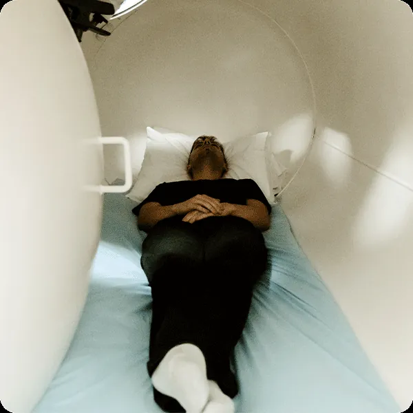 A patient lying inside the hyperbaric oxygen chamber