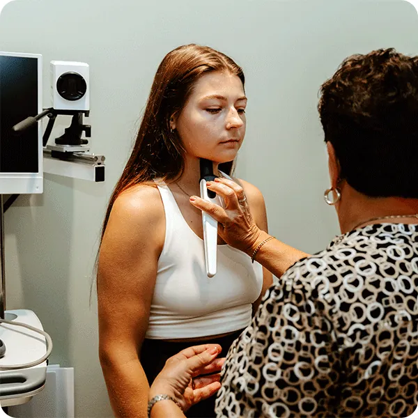 Shirley performs thermometry therapy under female patient's jaw