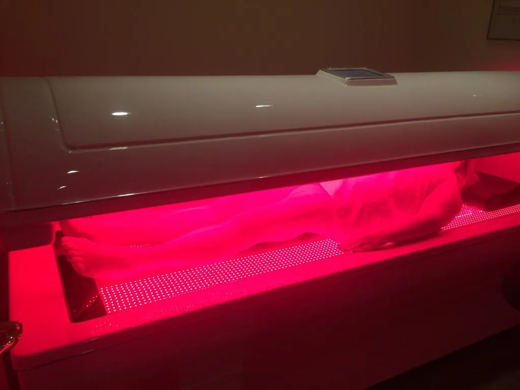 A patient relaxing during red light therapy
